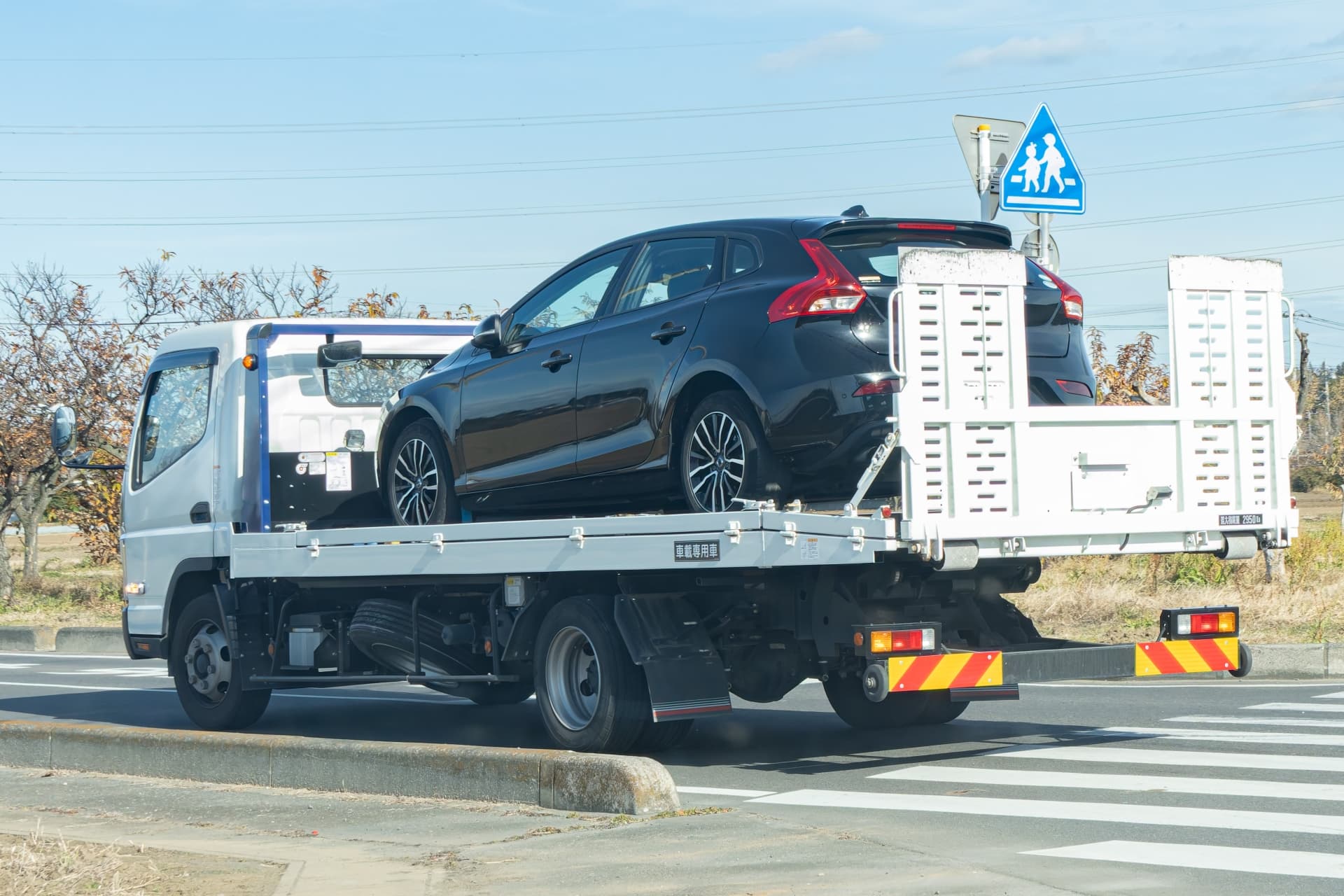 黒い車を積んだレッカー車